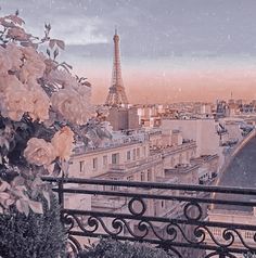 the eiffel tower towering over paris is seen in this sepia - toned photo