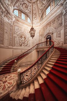 an ornately decorated staircase with red carpet