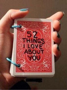 a woman's hand holding a playing card with the words 5 things love about you on it