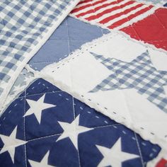 an american flag quilt with white stars and blue gingham checkerboard fabric