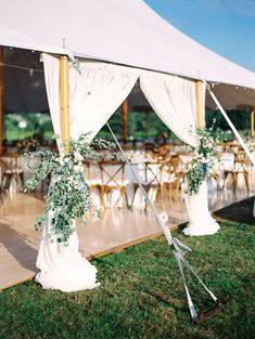 an outdoor tent set up for a wedding reception