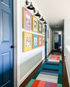 the hallway is decorated with colorful rugs and pictures on the wall, along with blue doors