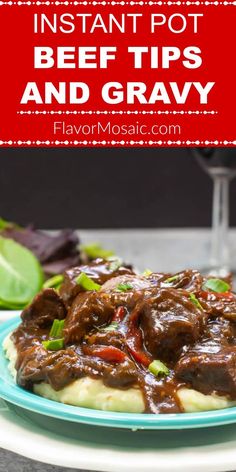 beef tips and gravy on top of mashed potatoes with red wine in the background