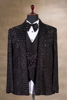 a tuxedo jacket and bow tie on a mannequin