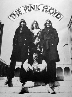 the pink floyd band posing on steps with their dog