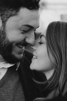 black and white photograph of a man and woman smiling at each other with their noses close together