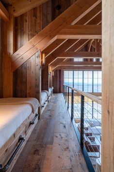 a bedroom with wooden walls and flooring next to a bed in a room that is made out of wood planks