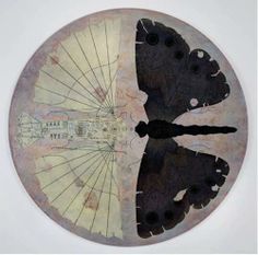 a clock with two butterflies on it and an upside down view of the clock face