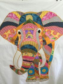 an elephant is painted on the back of a white t - shirt with colorful patterns