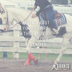 a man riding on the back of a white horse next to a wooden fence with a quote written above it