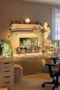 a desk with a monitor and some plants on it