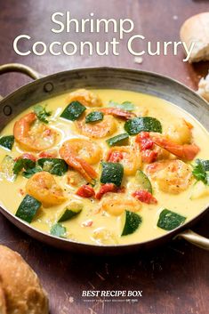 the cover of shrimp coconut curry is shown on a wooden table with bread in the background