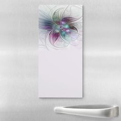 an abstract painting on the side of a stainless steel refrigerator with a white door and handle