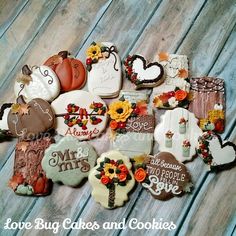 many decorated cookies on a wooden table with words and flowers in the shape of hearts