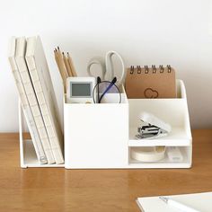 an office desk with various items on it and a calculator in the holder