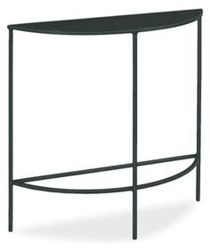 the curved metal table is black and has an iron frame