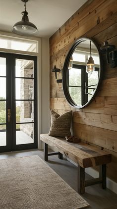 a wooden bench sitting in front of a round mirror on the side of a wall