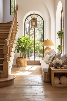 a living room filled with furniture next to a staircase