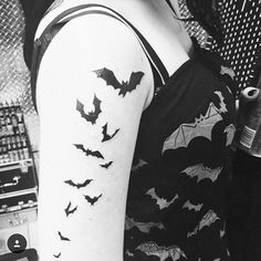 a woman with a bat tattoo on her arm