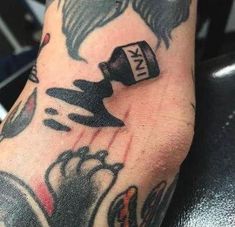 a person with a tattoo on their arm holding a bottle of ketchup in his hand