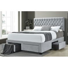 an upholstered bed with storage drawers in front of the headboard and foot board