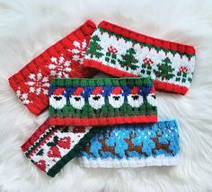 three knitted christmas headbands laying on top of a white furnishing