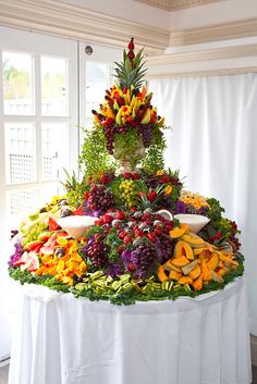 a table topped with lots of different types of fruits and veggies on top of it