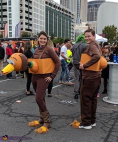 two people in costumes are standing on the street