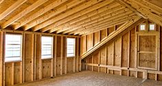 an empty room with wood paneling and windows in the ceiling is being built into the wall