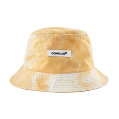 CONKLAB cotton twill bucket hat, tie-dye pattern throughout in yellow or purple, logo patch on front, quilted brim, twill lining. Composition - 100% Cotton One Size. Casual Yellow Cotton Bucket Hat, Casual Yellow Cotton Sun Hat, Yellow Cotton Casual Sun Hat, Casual Yellow Reversible Hat, Casual Yellow Reversible Sun Hat, Spring Cotton Sun Hat For Streetwear, Spring Yellow Reversible Hat, Yellow Cotton Bucket Hat With Short Brim, Casual Reversible Yellow Bucket Hat