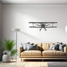 a living room with a couch, lamp and an airplane on the wall above it