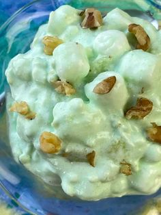 a close up of a plate of food with cheese and nuts on it in a bowl