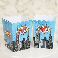 two paper cupcake cases with comic characters on them