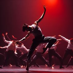 a group of dancers in motion on stage