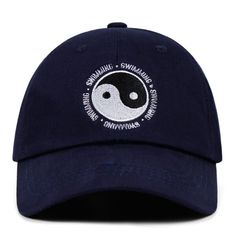 a blue hat with a yin symbol on the front and white lettering on the back