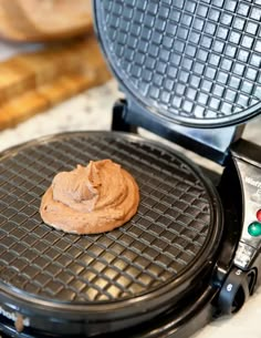 a waffle iron with some peanut butter on it