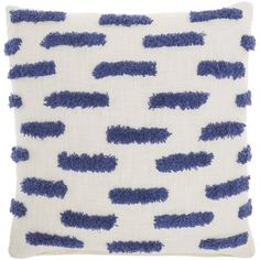 a blue and white pillow with fringes on it