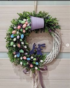 a wreath with an easter decoration hanging on the wall