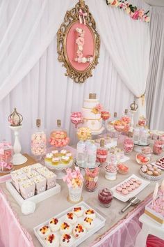 a table topped with lots of cakes and desserts