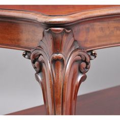 an ornately carved wooden table is shown in this close up view, with the top section