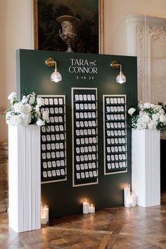 a table with candles and flowers on it in front of a sign that says tara & connor