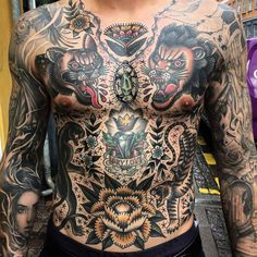 a man with lots of tattoos on his chest