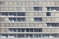 an apartment building with many windows and balconies