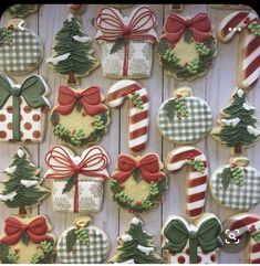 decorated christmas cookies are displayed on a table