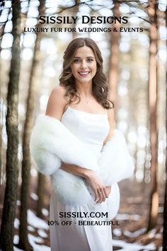 a woman in a white dress and fur stoler posing for a photo with trees behind her