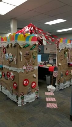 an office cubicle decorated for christmas with gingerbreads and candy canes on the walls