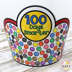 a paper cup with the words 100 days smarter written on it and colorful polka dots