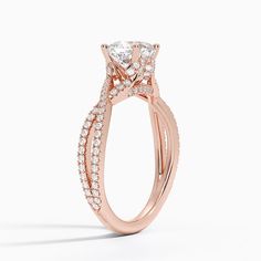 a rose gold engagement ring with an oval shaped center stone surrounded by small round diamonds