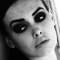 black and white photo of a woman with eye makeup