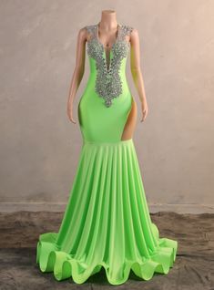 Rock the night away in this dazzling neon green prom dress, designed to turn heads and make a lasting impression. The gown boasts a plunging neckline adorned with elaborate silver beadwork, adding a touch of elegance and sophistication. The fitted silhouette hugs your curves, highlighting your figure, while the high side slit offers a daring glimpse of leg. The mermaid-style skirt flows seamlessly into a dramatic sweep train, ensuring you move with grace and poise. This dress is perfect for those who wish to make a bold and unforgettable statement at their prom or any formal occasion. The vibrant color combined with the intricate detailing makes this gown a standout choice. Step into this dress and experience the magic of a night filled with elegance and charm, leaving everyone in awe of y Neon Green Prom Dress, Red Velvet Prom Dress, Short Sleeve Prom Dress, Vintage Simple Wedding Dress, Champagne Homecoming Dresses, Short Sleeve Prom Dresses, Black Mermaid Prom Dress, Crystal Prom Dress, Sleeve Prom Dress